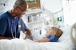 Young Girl Talking To Male Nurse In Intensive Care Unit photo