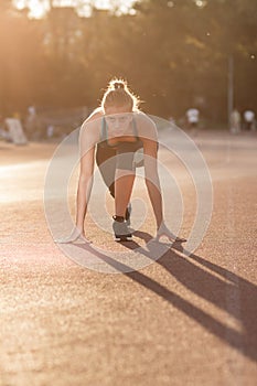 Young girl teenager sprinter start position