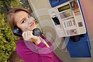 Young girl in a telephone booth