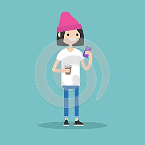 Young girl texting on her smartphone and holding a cup of coffee