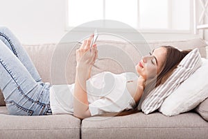 Young girl texting on smartphone