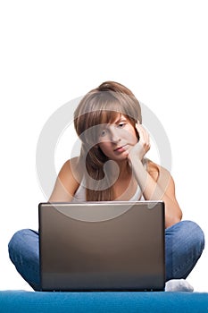 Young girl thinking with laptop