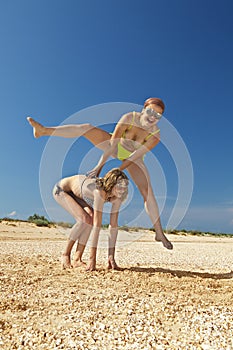 Young girl to jump across her friend