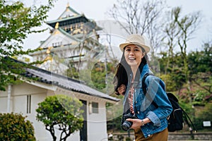 Young girl tourist face camera smiling holding slr camera. professional photographer always travel with her digicam. lady traveler