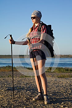 Young girl tourist with nordic walking