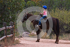 A young girl on a trail ride in a Colorado Park