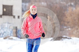 Young girl on trail running training in winter