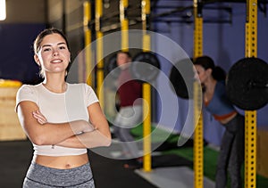 Young girl trainer in sportswear poses in fitness center gym. Active lifestyle, daily workouts in crossfit gym