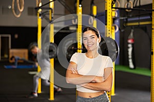 Young girl trainer in sportswear poses in fitness center gym. Active lifestyle, daily workouts in crossfit gym