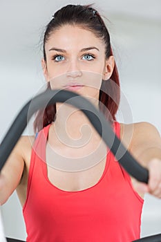 Young girl training at gym on stepping machine