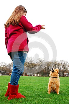 A young girl trains her dog