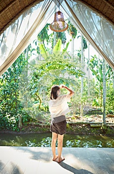 Young girl traveling on vacation in a relaxing place with beautiful tropical rainforest