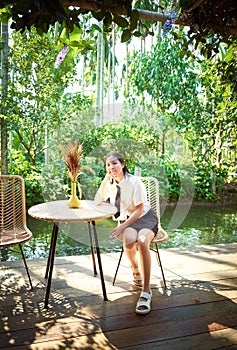 Young girl traveling on vacation in a relaxing place with beautiful tropical rainforest