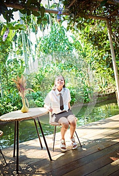 Young girl traveling on vacation in a relaxing place with beautiful tropical rainforest