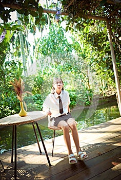 Young girl traveling on vacation in a relaxing place with beautiful tropical rainforest