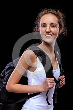 Young girl-traveller with big black backpack