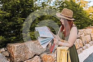 young girl travelling, lost, looking for directions to her holiday destination on a map. tourist asking for directions.