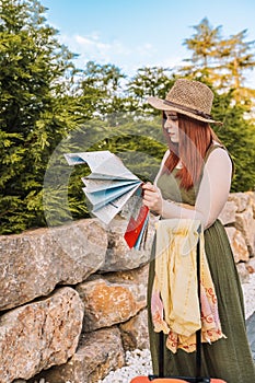 young girl travelling, lost, looking for directions to her holiday destination on a map. tourist asking for directions.