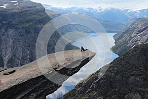 Young girl on the Troll's tongue (norw. Trolltunga).