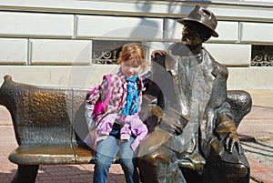 Young girl on Tuwim`s bench in Lodz photo