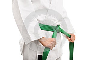 Young girl tying her karate belt