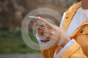 Young girl typing sms to friend