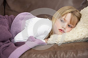 Young Girl Unwell Lying On Sofa