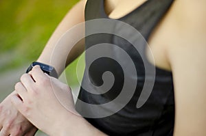 A young girl uses a fitness tracker. Smartwatch.