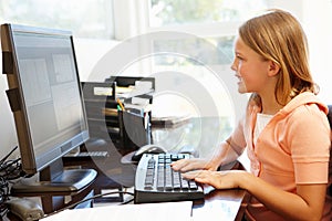 Young girl using computer at home