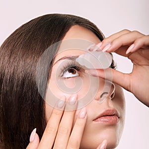 Young girl using eye drops. Glaucoma recovery