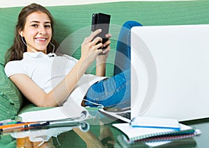 Young girl using laptop at home