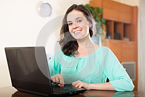 Young girl using laptop at home