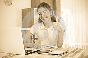 Young girl using laptop at home