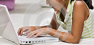 Young Girl Using Laptop for learning at home