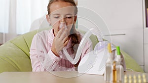 Young girl using nebuliser inhaler - rack focus