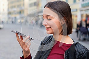 Young girl using vocal assistant on smart phone