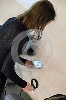 A young girl in a virtual reality glasses and and Holding Controllers. Using VR technologies in