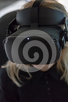 Young girl in a virtual reality glasses. Using VR technologies in everyday life. Introduction of