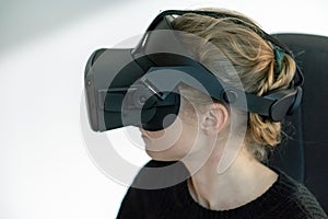 Young girl in a virtual reality glasses. Using VR technologies in everyday life. Introduction of