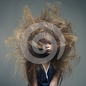 Young girl with a volume fashionable hairstyle