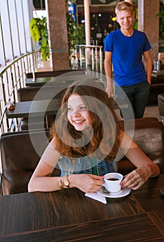 Young girl waiting for a boyfriend in cafe