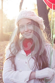 Young girl walking in the autumn park