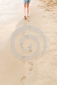 Young girl walking on the beach