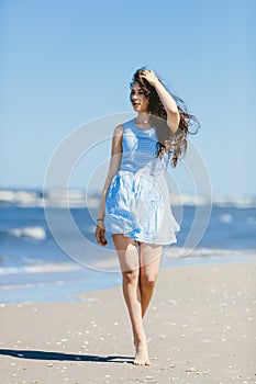 Young girl walking on a coast