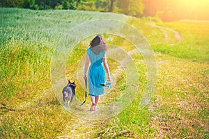 Young girl walking with a dog