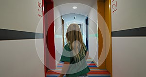 Young girl walking down colorful corridor