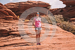 Young girl walking down the horse shoe bend cliffs