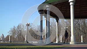 Young girl walking in park and feed pigeons