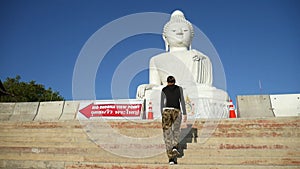 Young Girl Walking Up Stairs to White Big Buddha Statue. Phuket, Thailand. HD 1080p.