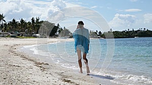 Young girl walks along the beach.